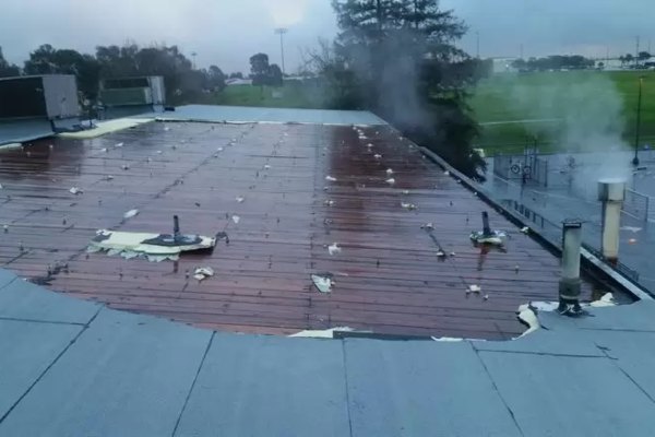 Roof Repairs needed on flat roof with missing roofing system in mentor ohio
