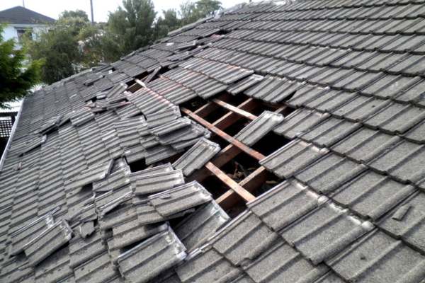 Storm Damage with missing tiles on roof in mentor ohio