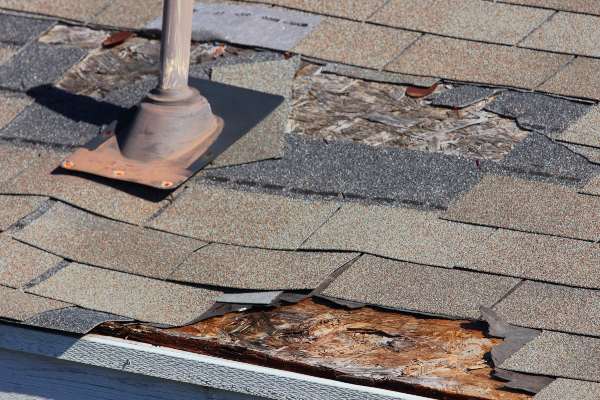 asphalt roof in need of repairs with missing shingles in mentor ohio