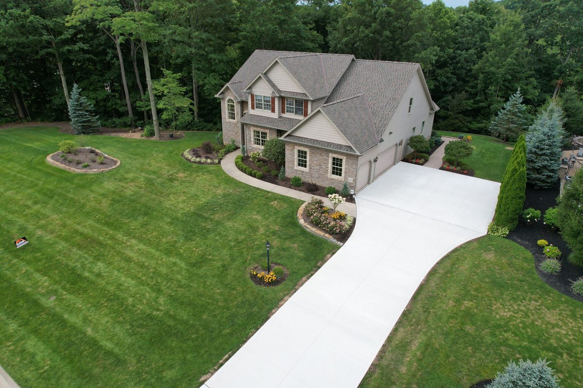 Two-story stone and vinyl home with a new architectural asphalt shingle roof