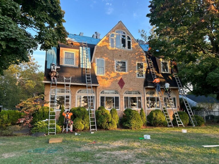 RAW Roofing Solutions crew re-roofing a cedar shingle-sided home in Northeast Ohio