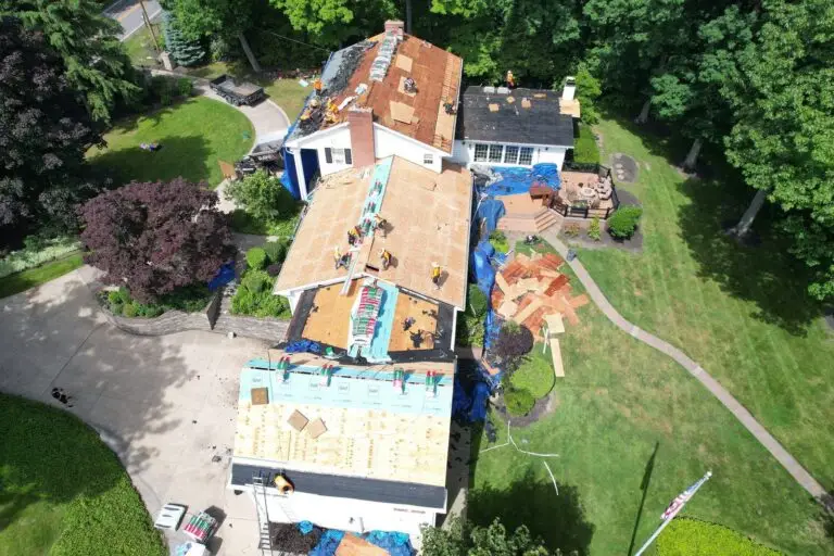 RAW Roofing Solutions crew replacing a roof on a home with a large wooded lot in Northeast Ohio