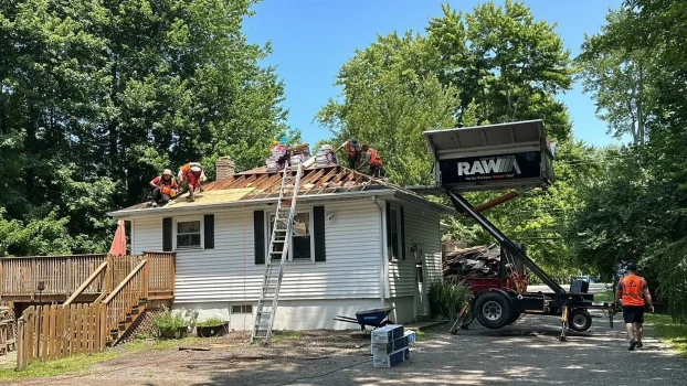 RAW Roofing Solutions crew tearing off an old roof on a Northeast Ohio ranch home
